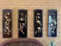 All four wall panels displayed on brick wall
