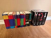 All books standing showing spines: Harry Potter series, Tolkien titles, Twilight boxed set