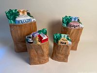 Full view of four ceramic brown bag canisters