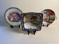 All three decorative transferware plates on stands