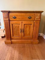 front view of wooden buffet console closed