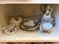 Cabinet shelf showing full group of Nippon porcelain pieces