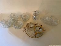 Group shot: teacups, gold-trim set, pressed glass set, sugar jar