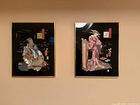 Both framed Geisha prints hung side by side on wall