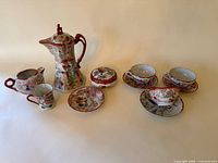 Full view of the porcelain hot chocolate set showing all pieces