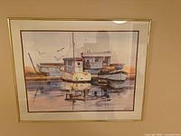Front view of framed Joan Burr watercolour showing harbour scene