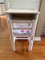 Front view of white kids desk with chair tucked underneath