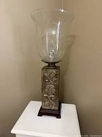 Full view of lamp showing glass globe and base