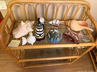 Full view of all coastal decor pieces on rattan shelf