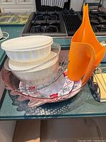 Overall view showing casseroles, glass bowl, plates, tray, holder