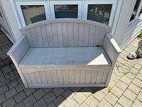 Front view of grey resin storage bench closed