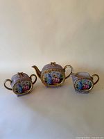 Front view of teapot, sugar bowl and creamer