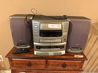 Front view of Sanyo stereo system with both speakers and remote