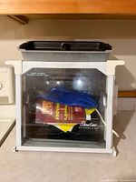 Front view of rotisserie oven with accessories visible through glass door