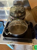 T-fal Actifry air fryer, black saucepan with glass lid, black baking tray