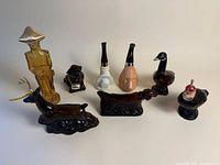 Group shot of all eight Avon figural perfume bottles