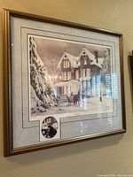 Framed print showing winter house scene with sleigh