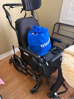 Side view of black manual wheelchair with accessories