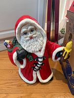 Front view of Santa resin statue standing on floor