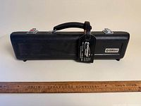 Closed Yamaha flute case front view with ruler for scale