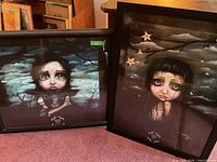 Both framed prints side by side on floor