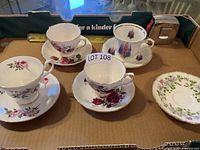 Group shot of all cup and saucer sets plus extra saucer