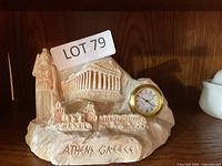 Front view of carved Athens souvenir sculpture with clock and inscription