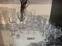 Group shot of assorted stemware and tumbler on shelf
