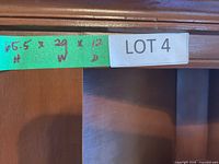 green tape label showing lot sticker and hand-written dimensions