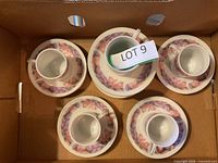 Boxed view showing five cups nested on six saucers