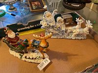 Both Santa sleigh figurines side by side for size and condition reference