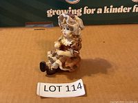Front view of seated Victorian-style girl figurine