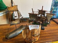 All three decorative ship models on wooden surface
