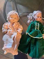 Two dolls side by side on table