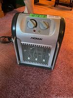 Front view showing brand, grille, control knobs, power indicator