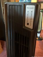 Honeywell logo and vent grille on front of tower fan