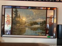 Full view of framed artwork showing landscape print with mirrored floral side panels