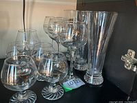 Group view of all stemmed glasses and two tall flared vases
