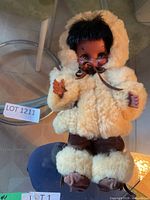 Front view of doll in faux fur parka