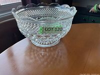 Side view of clear pressed glass bowl on table