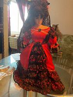 Full view of Margarita porcelain doll standing on table