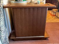 Front view of wood and vinyl portable bar on platform base