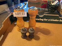 Wooden mills and metal shakers grouped