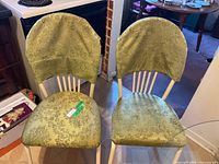 Two chairs showing upholstered seats and backrest slipcovers