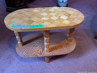 Oblique view showing overall table with parquet top, turned legs and lower shelf