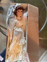Full view of doll in box showing dress and veil