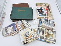 Stacks of loose photographs with three photo albums