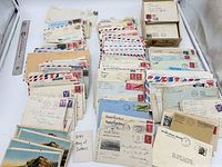 Wide view of entire assortment of envelopes, letters and postcards laid out