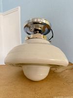 Side profile showing glass shade and chrome hardware