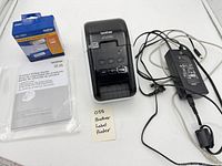 Full lot showing printer, power adapter, label roll box, manual